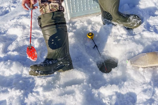 hole in the ice for fishing rod and other accessories for winter fishing