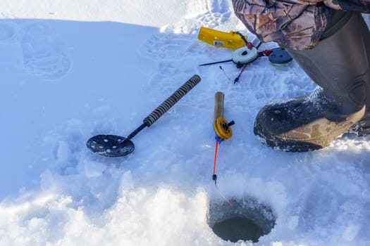hole in the ice for fishing rod and other accessories for winter fishing