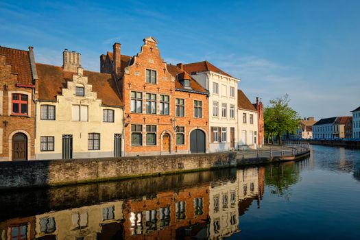 Typical Belgian cityscape Europe tourism concept - canal and old houses on sunset. Bruges (Brugge), Belgium