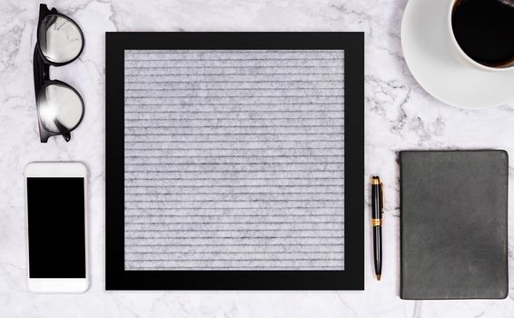 free word on blank letter board in grey color on white marble desk background with coffee cup , notebook , pen , glasses and mobile phone , flat lay composition in black tone stationery color