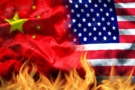 waving USA and China flag with fire on foreground. serious trade tension or trade war between US and China, financial concept