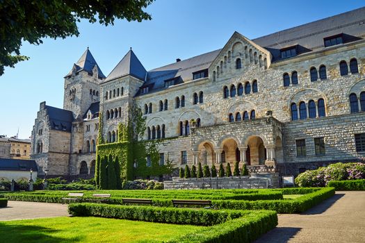 A historic stone imperial castle with a garden in Poznan