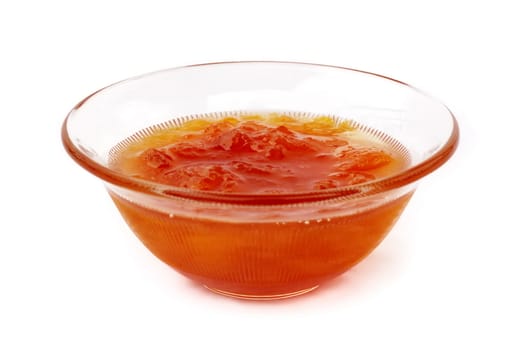Cup of apricot marmalade on white background