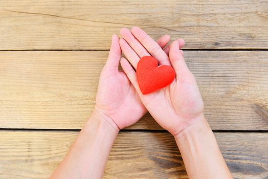 hands holding heart give love philanthropy donate help warmth take care valentines day / health care love organ donation family insurance world health day hope gratitude covid-19 coronavirus relief 