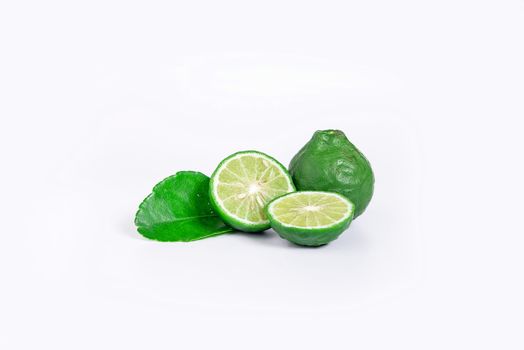 fresh bergamot fruit with cut in half and green leaf isolated on white background