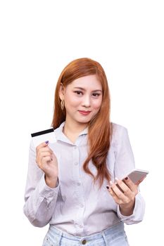 smiling Asian woman in casual shirt holding mobile phone and showing credit card for shopping online while making orders via the internet. studio shoot ,isolated on white background with clipping path