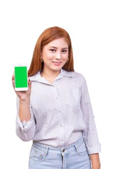 smiling Asian woman holding mobile smartphone with blank green screen standing on white background , clipping path include