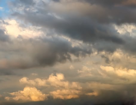 Beautiful panorama of orange and yellow clouds at sunrise and sunset in a blue sky