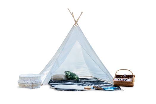 outdoor romantic white picnic tent with picnic food basket , mat and pillow isolated on a white background