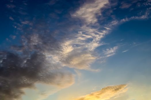 Beautiful panorama of orange and yellow clouds at sunrise and sunset in a blue sky
