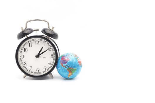 Alarm clock with world globe on white background. World time concept. Selective focus.