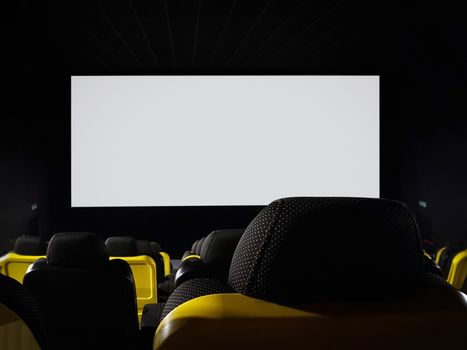 Mock-up of an empty cinema hall with blank white screen to add advertisement (copy space)