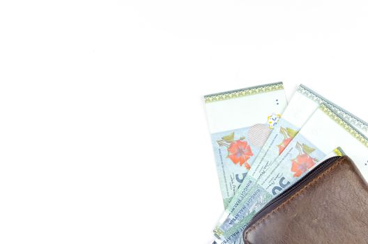 Malaysia bank note with leather purse on white background.