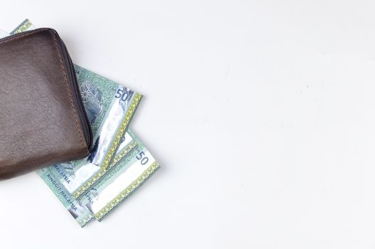 Malaysia bank note with leather purse on white background.
