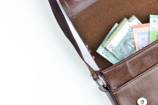 Malaysia bank note with sling bag on white background.