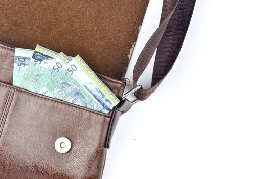 Malaysia bank note with sling bag on white background.