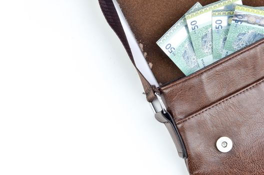 Malaysia bank note with sling bag on white background.