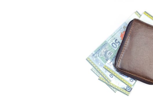 Malaysia bank note with leather purse on white background.