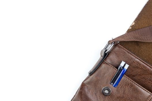 Brown sling bag on white background. Selective focus.