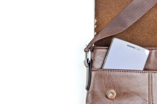 Leather sling bag with smartphone on white background.