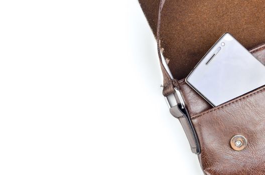 Leather sling bag with smartphone on white background.