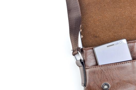 Leather sling bag with smartphone on white background.