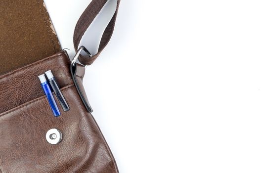 Brown sling bag on white background. Selective focus.