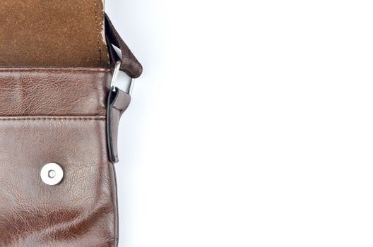 Brown sling bag on white background. Selective focus.