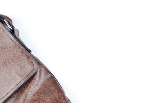 Brown sling bag on white background. Selective focus.