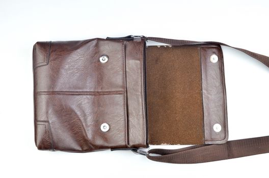 Brown sling bag on white background. Selective focus.