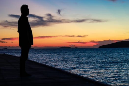 Silhouette of a man who came to watch the morning sun At Khao Laem Ya National Park, Rayong.