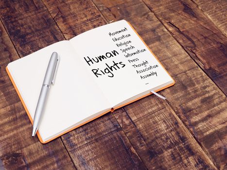 human rights concept. human rights mind map with hand writing on note book at the wooden table