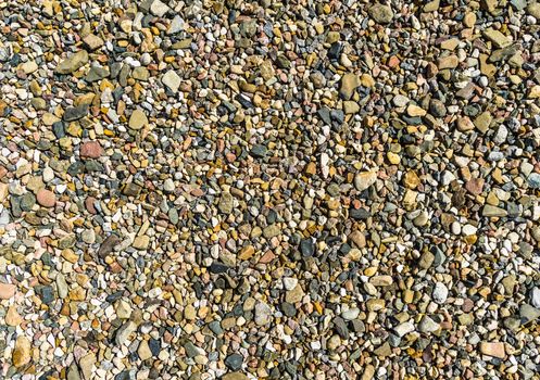 Abstract admission of a coloured gravel. Background and texture. Completely as a clearance usable.