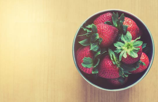 Soft light strawberry on wood table, love concept, vintage and retro style