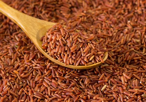 Picture of close up wooden spoon and brown rice 