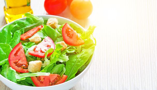 Fresh salad on wood table with sunlight, diet food concept