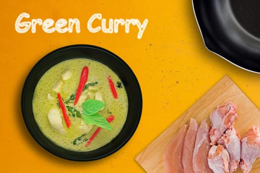 Green curry chicken on yellow background