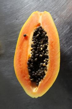 Half a papaya fruit on the kitchen table.