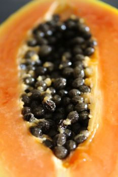 Macro of seeds inside one half of a papaya fruit.