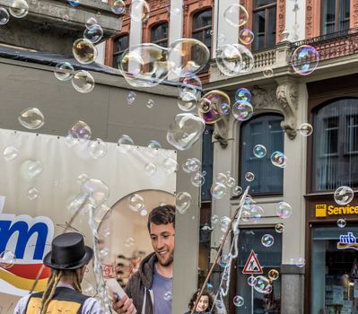 Leipzig, Saxony, Germany - October 21 2017: Street artists earn a few coins through large soap bubbles in the pedestrian zone of Leipzig