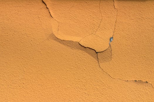 Peeling painted wall, texture, grunge background, cracked paint with orange wall.