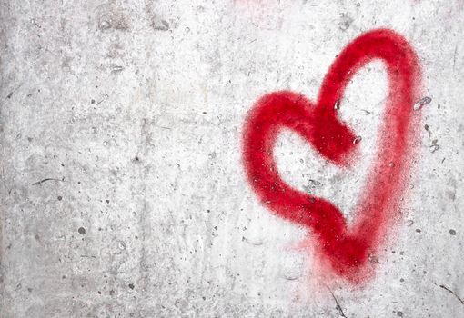 Red heart hand drawn on concrete wall