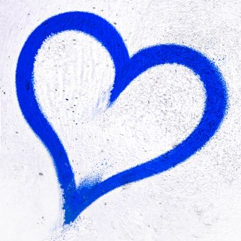 Concept or conceptual painted deep blue abstract heart shape love symbol, dirty wall background, metaphor to urban and romantic valentine, grungy style.