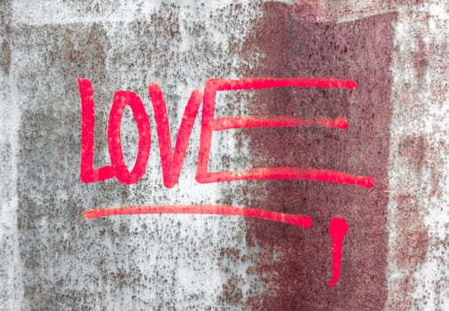 Word LOVE written over the grunge rusty background