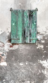 Picturesque grunge green window on the wall