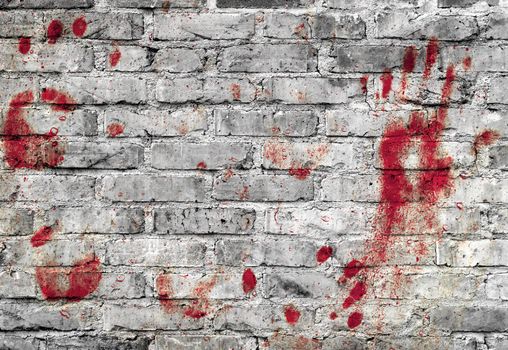 Bloody handprints and blotches of blood on grunge wall. Background for spooky content, halloween and more.