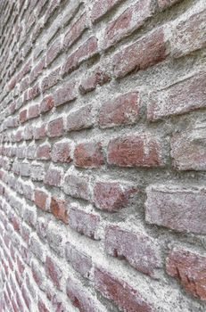 Old Red brick wall. Oblique angle. Ideal for background.