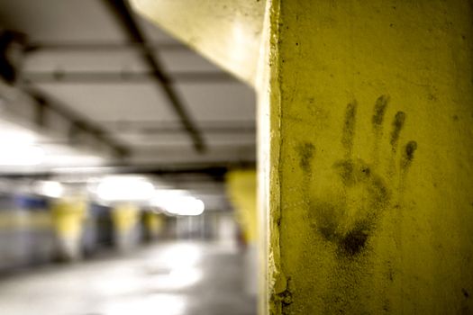 The imprint of a hand on a yellow pillar.