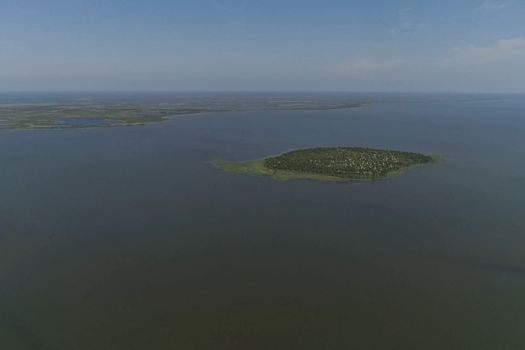 View from above on the coastal forest tundra. River and islands with taiga.