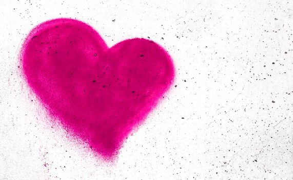 Pink heart shaped on grungy wall background with copy space